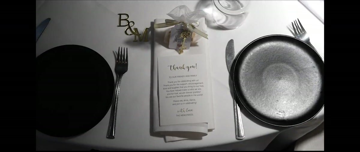 A black and white place setting with the couple's monogram and a thank you card